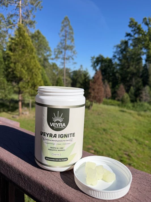 Veyra Ignite supplement container with pills on a wooden surface outdoors
