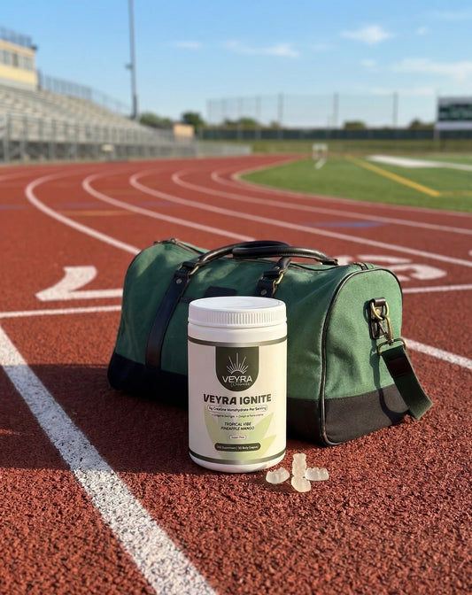 Veyra Ignite creatine gummies bottle next to a track field and gym bag