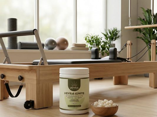 Fitness lifestyle scene with Veyra Ignite bottle, gym bag, and Pilates reformer